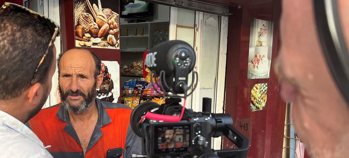 A customer chats with UN News at a Tunis neighborhood bakery in Ettadhamen.